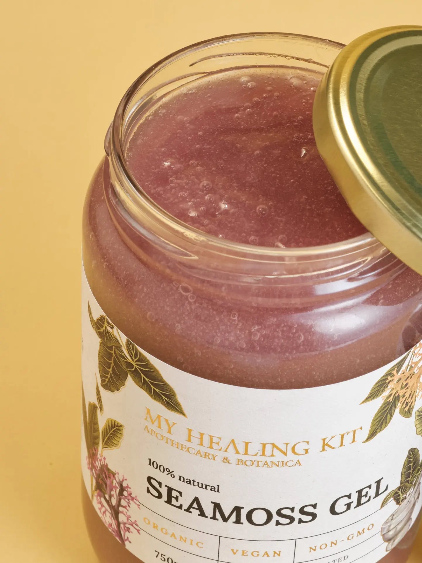 Open purple sea moss jar revealing its colorful contents.